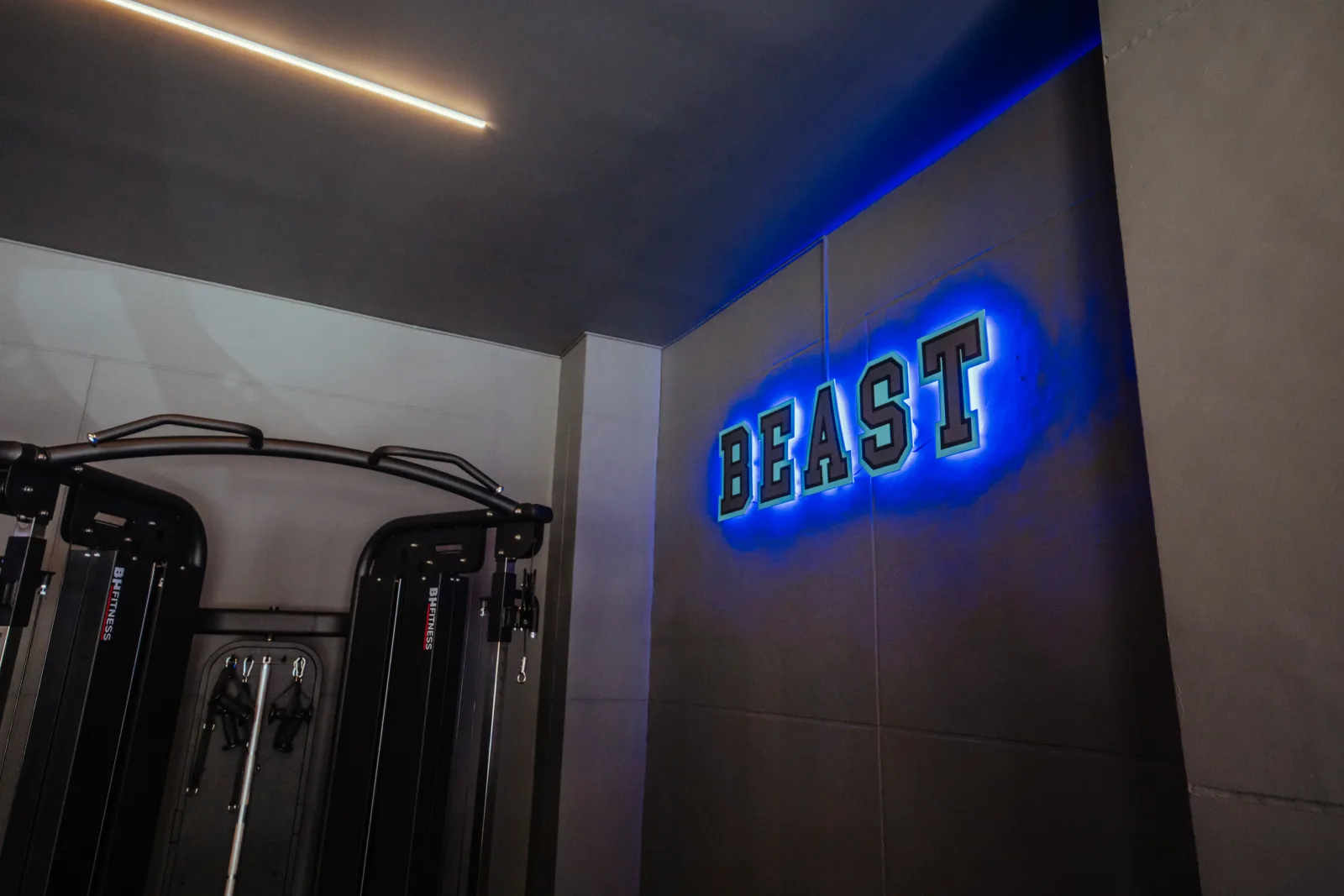 Blue illuminated BEAST sign above premium cable machines