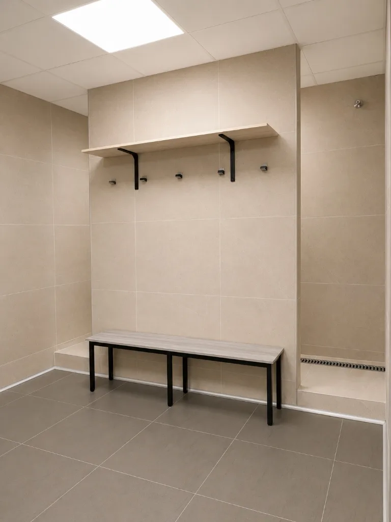 Clean BEAST changing room with bench, hooks, shelf, and shower
